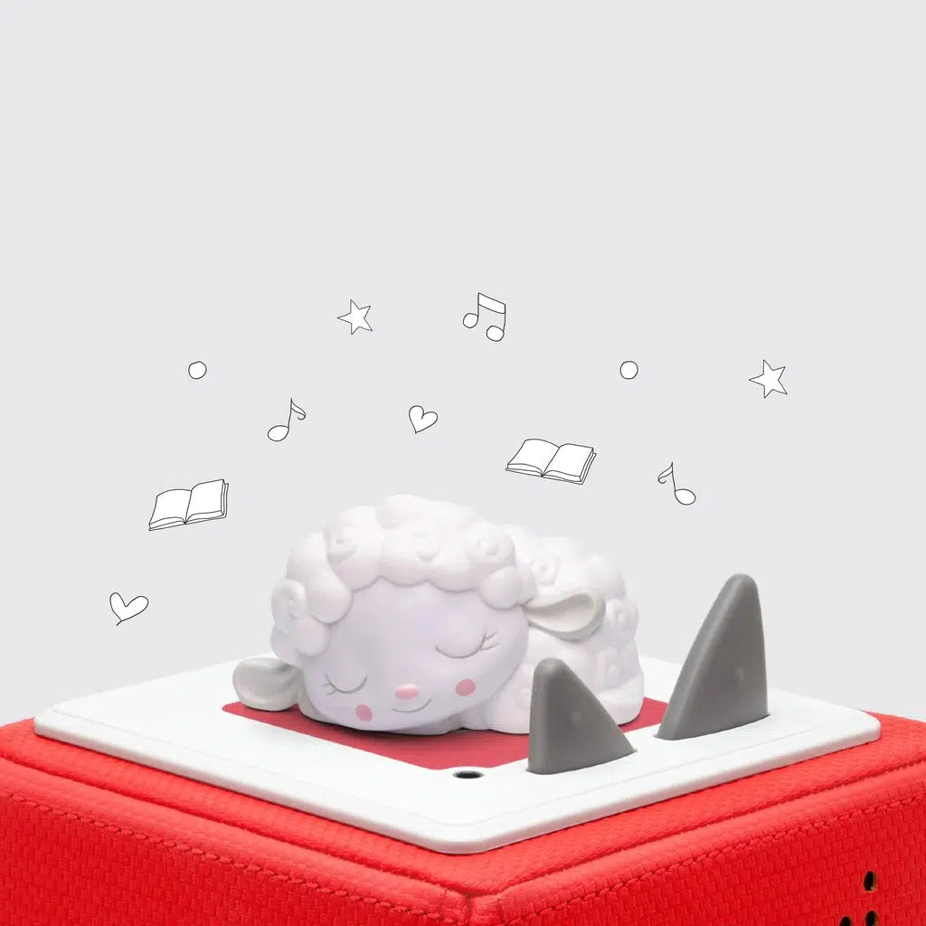 Sheep Tonie figure shown on a red toniebox | tonie figure is a cartoonish sheep with curly white wool that's curled up and sleeping