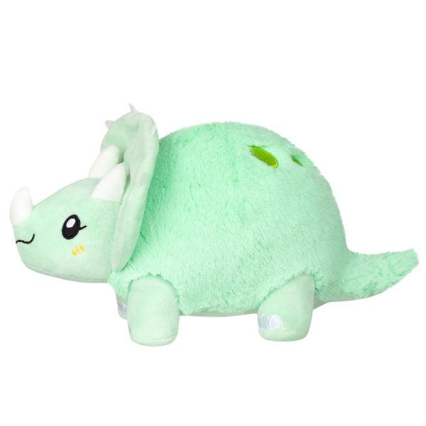 Side view of the plush. Shows that there is a tail coming off the back of the plush.
