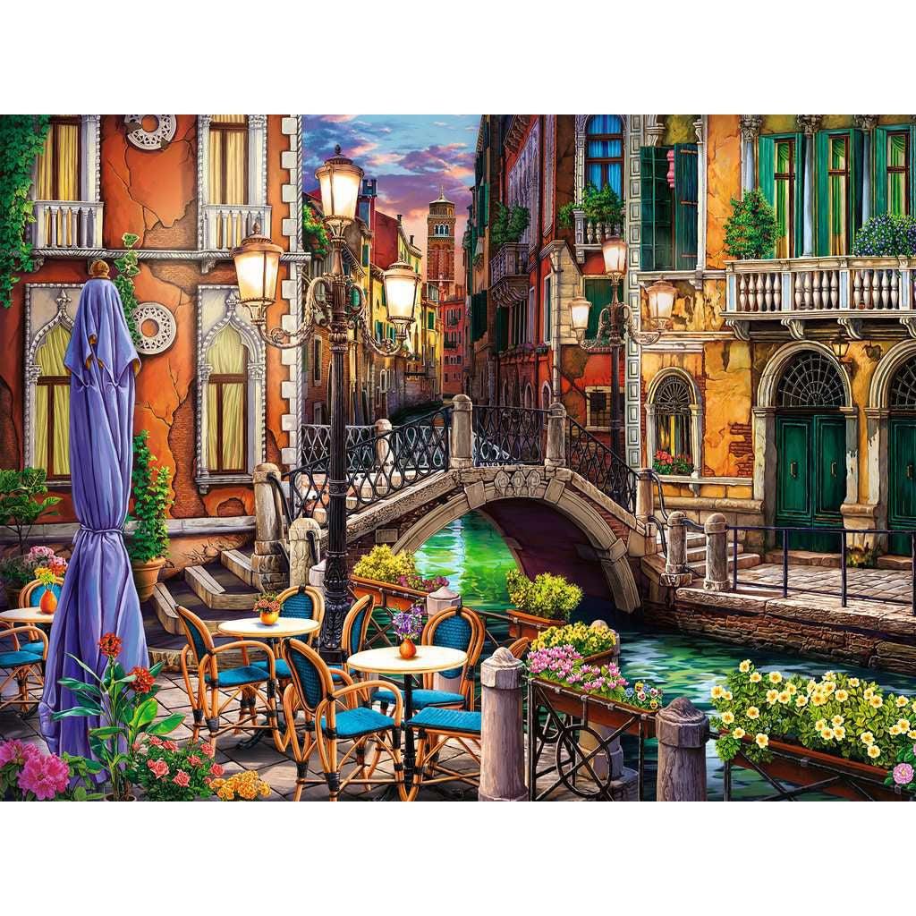 Puzzle image | Illustration shows view of a city "street" in Venice. A canal with green water runs under a pedestrian bridge and down between rows of tall antique buildings. | On one side of the bridge is a patio with seating and flower boxes. | The scene us set at dusk and streetlights line the canal.