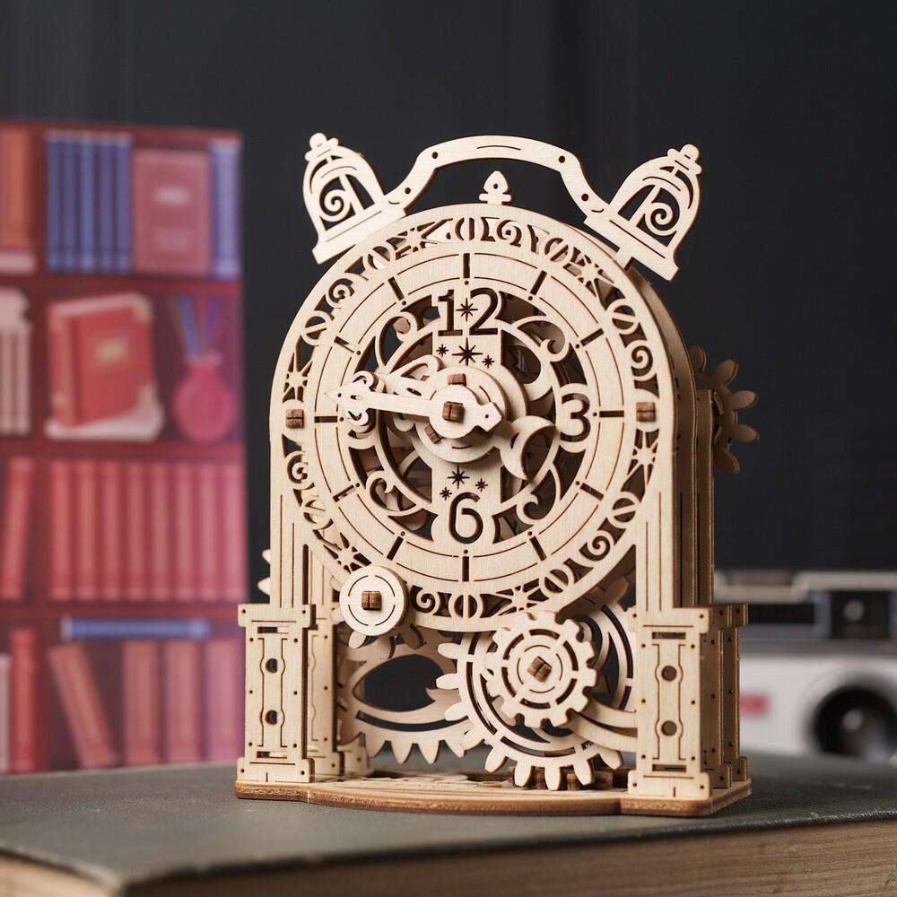 Assembled model out of packaging | Model is a vintage style alarm clock composed of raw wooden gear elements and a wooden venetian style body and clock face. | The model  has moving elements that can be seen from all angles.