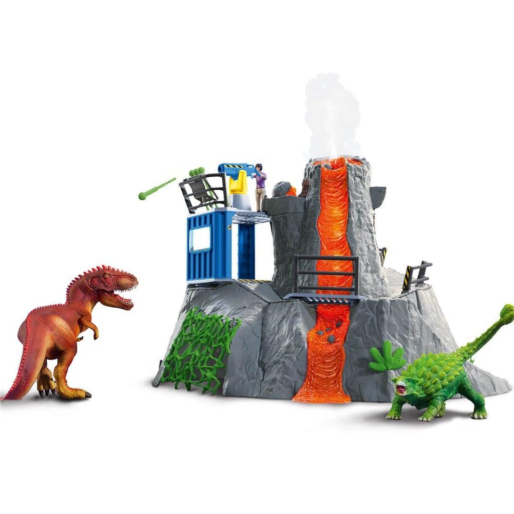 Image of the play set outside of the box. The set includes a volcano with a research lab set up on the side of it. There is a cave underneath the volcano, and the set includes a researcher and two dinosaurs.