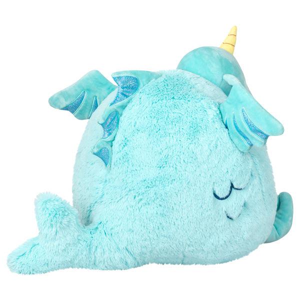 Back view of the plush. Shows that it has a small sea fin on its back and its tail is a sideways dolphin tail.