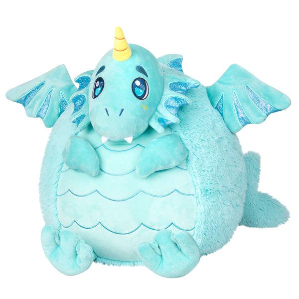 Image of the Water Dragon squishable. It is a light blue dragon with webbed feet and small wings. It has a yellow unicorn horn.