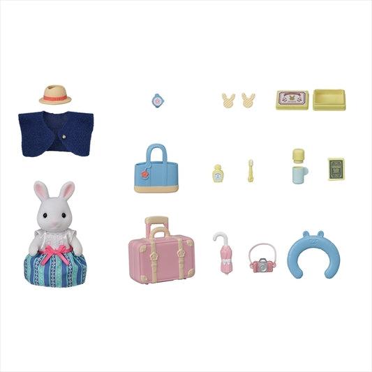 Image of all the included pieces outside of the packaging. It includes a white rabbit mom with a unique outfit (dress, sweater, and straw hat), luggage, neck pillow, and assorted travel items.