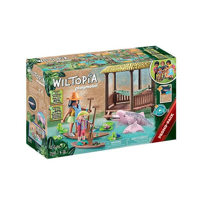 The front of the box shows the playset, there are 2 figures standing on paddle boards, 2 pink dolphins, and a veranda with a hammock