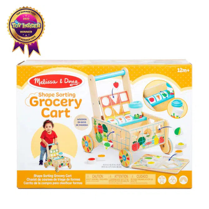 Image of the packaging for the Wooden Shape Sorting Grocery Cart play set. The front of the box has a picture of the cart with many features emphasized. It also has a picture of a little girl pushing the cart.