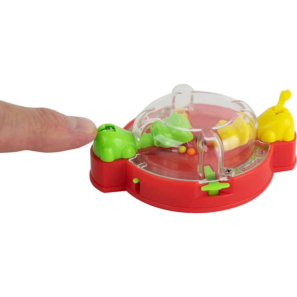 Shows a finger operating the small toy for a size comparison. The game is about the size of a child's palm.