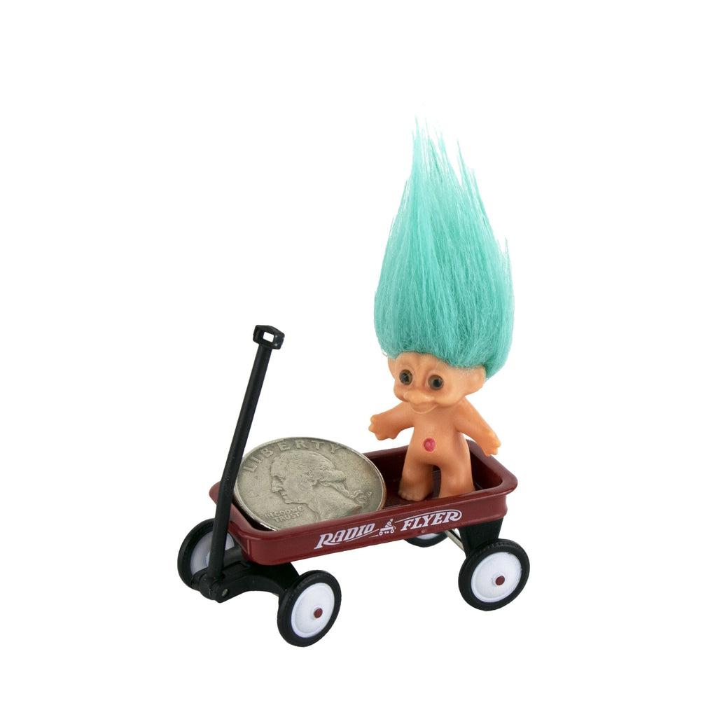 Shows close up of the wagon holding a quarter and a tiny troll man. The quarter almost doesn't fit in the wagon.